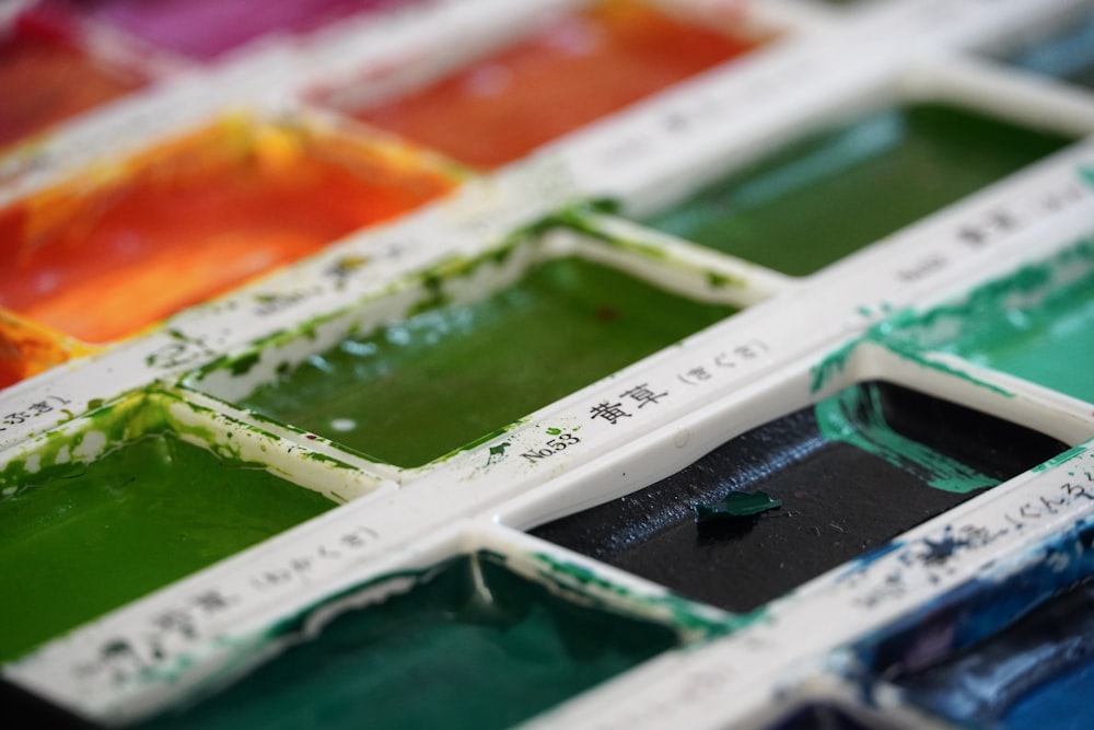 a close up of a tray of different colors of paint