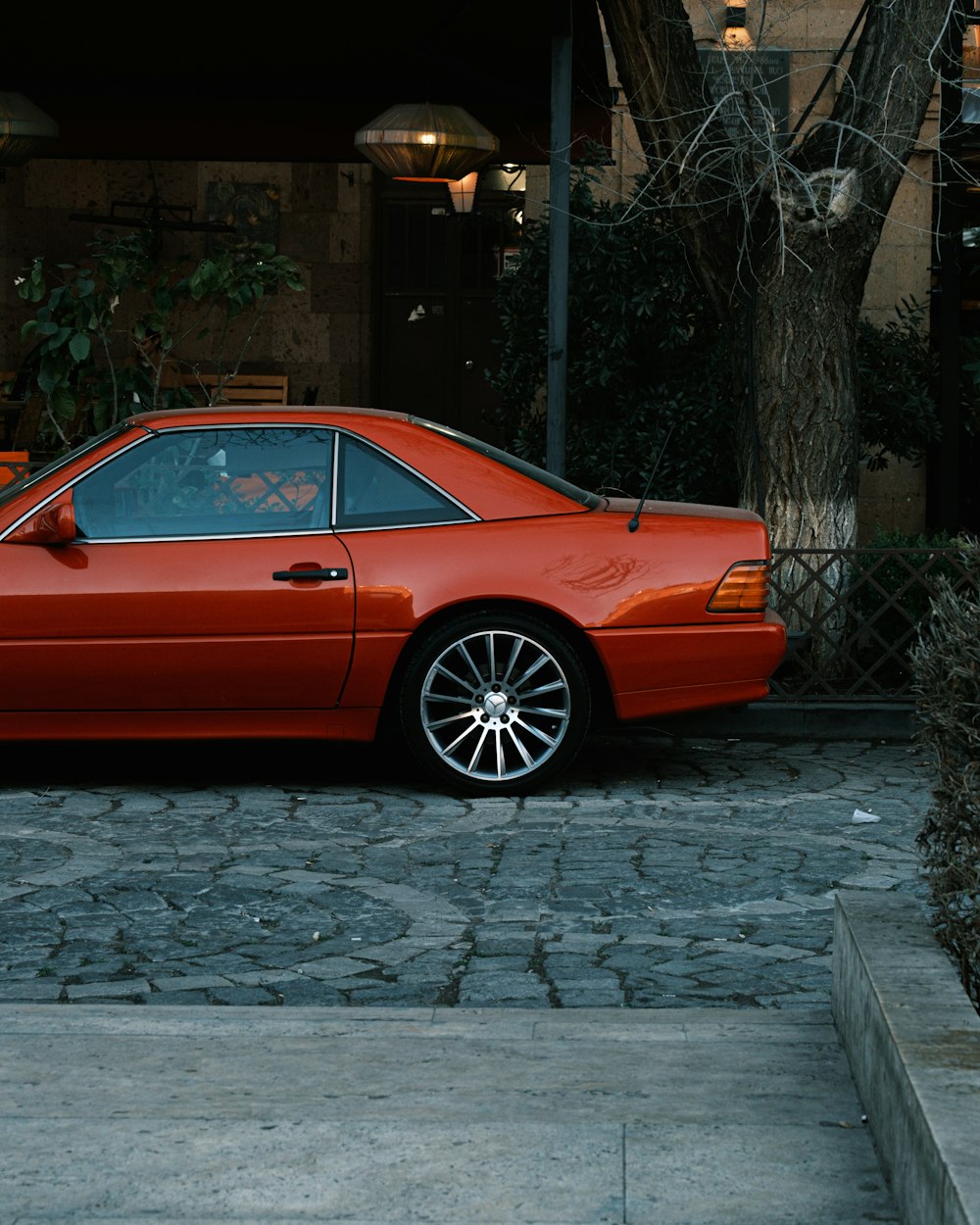 a red sports car parked in front of a building