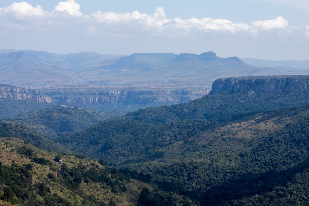 a view of a valley with mountains in the background