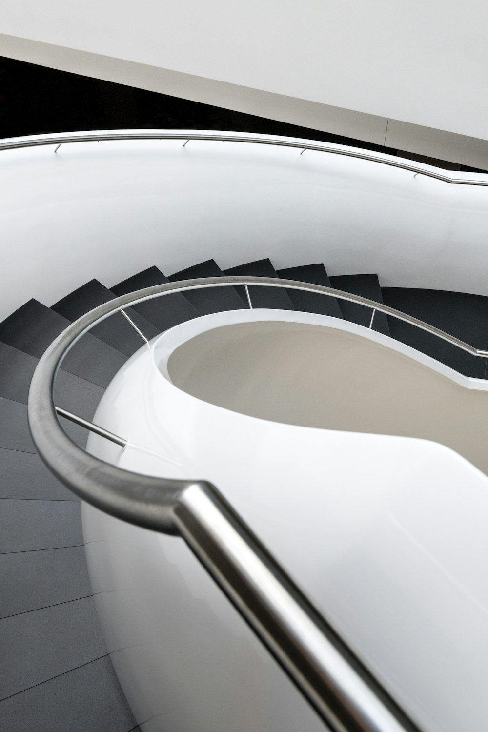 a close up of a spiral staircase with a hand rail