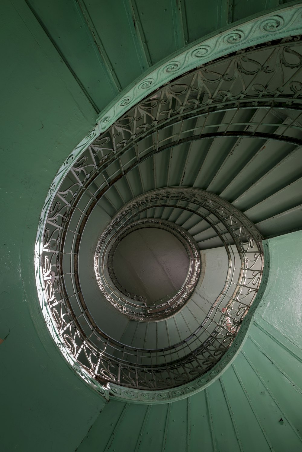 a spiral staircase in a green building