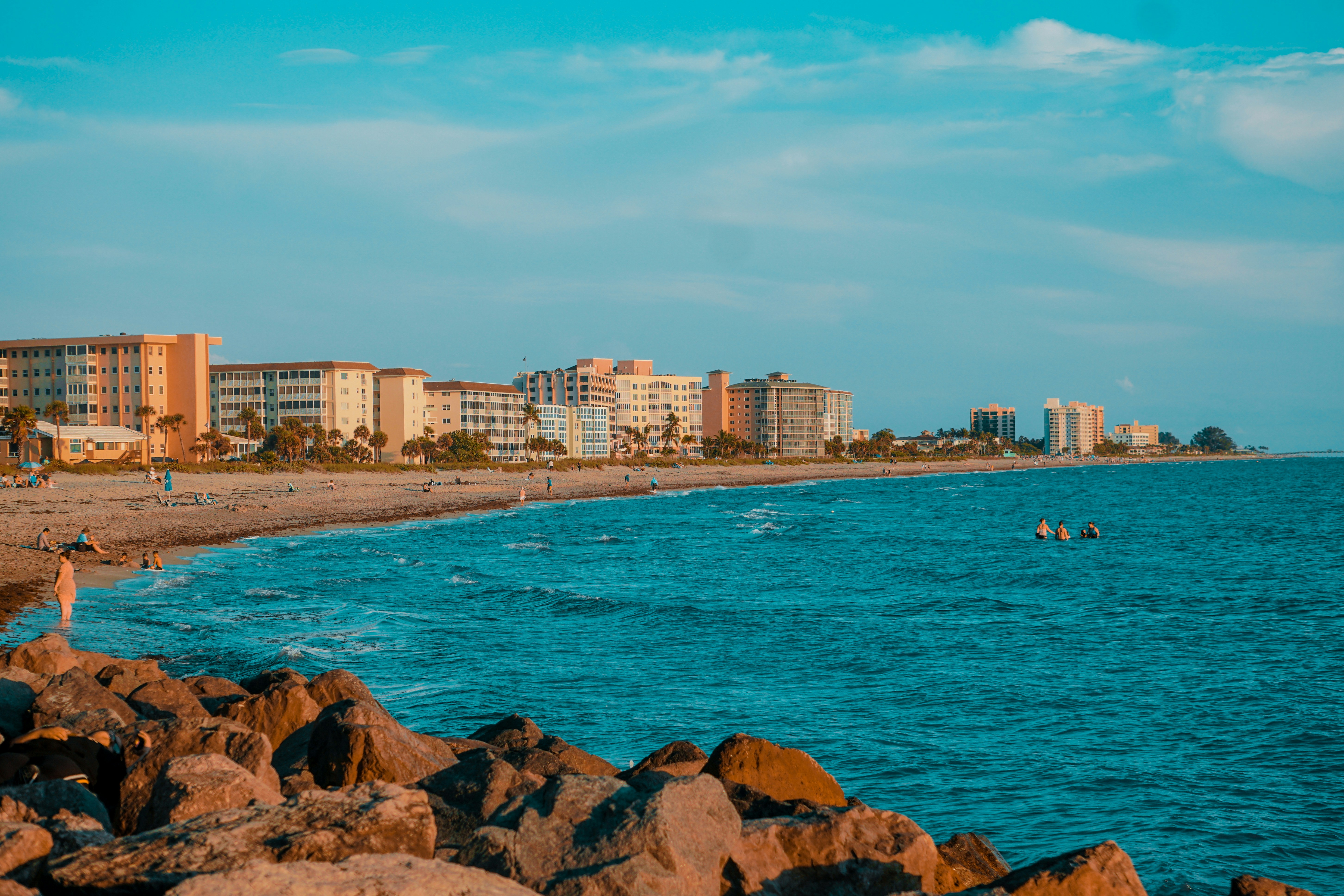 a man standing on a beach next to a body of water