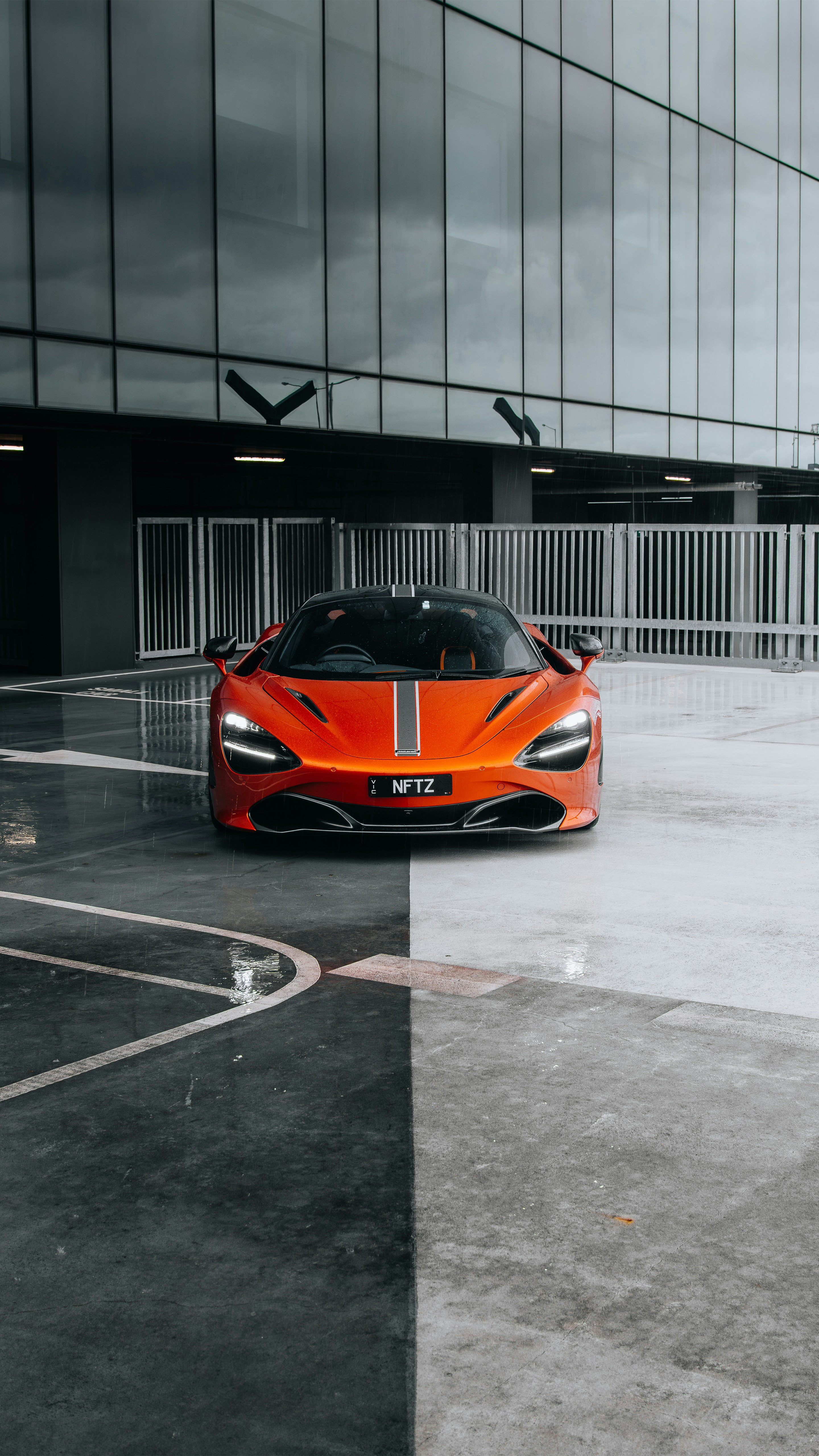 an orange sports car parked in a parking lot