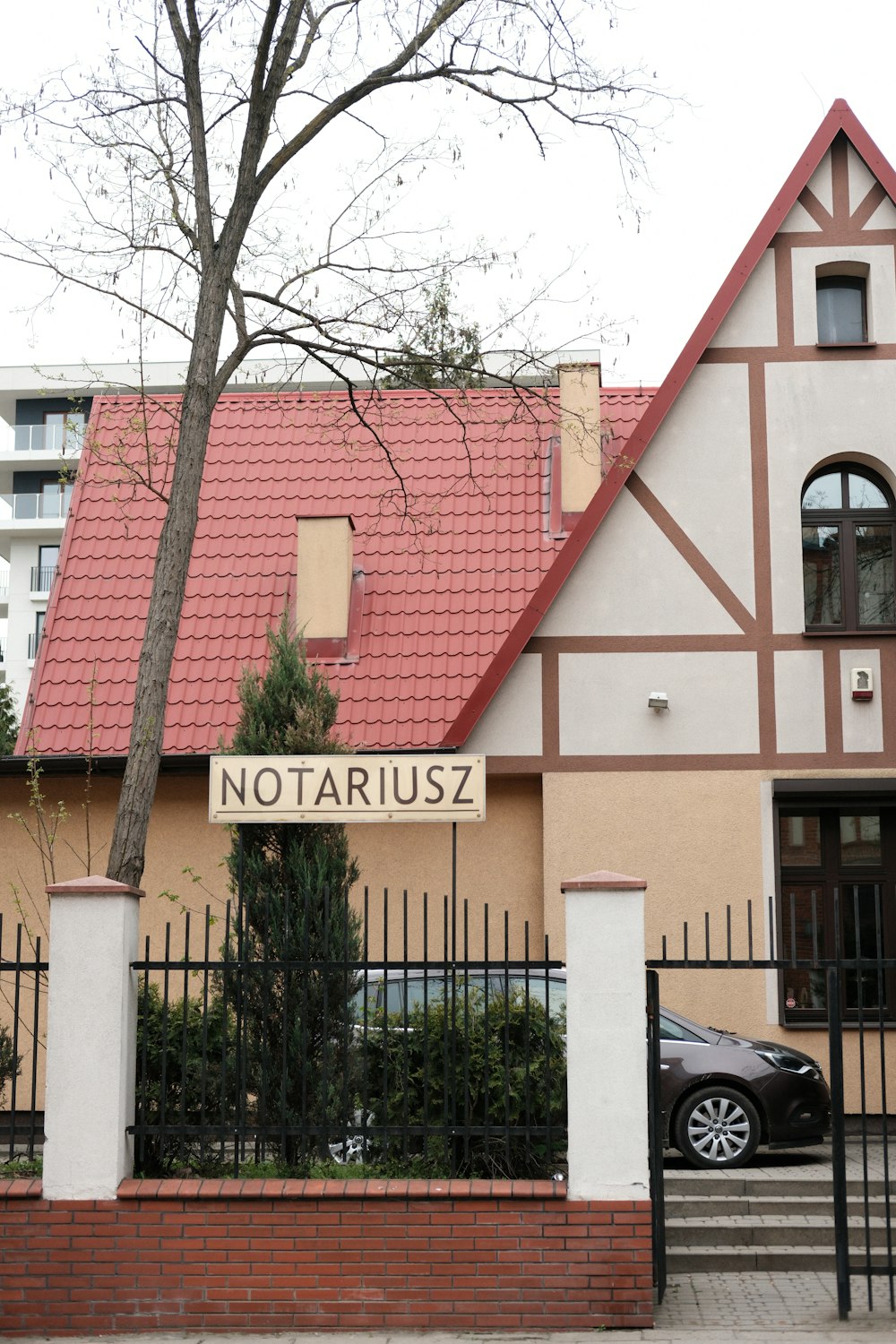 a black car is parked in front of a house