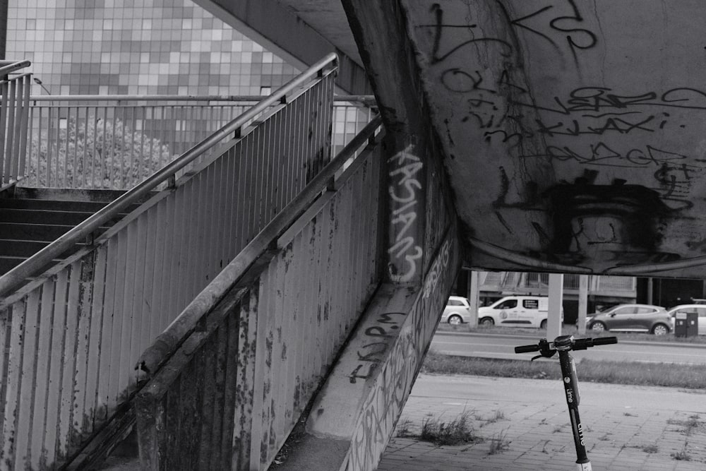 a scooter parked next to a wall with graffiti on it