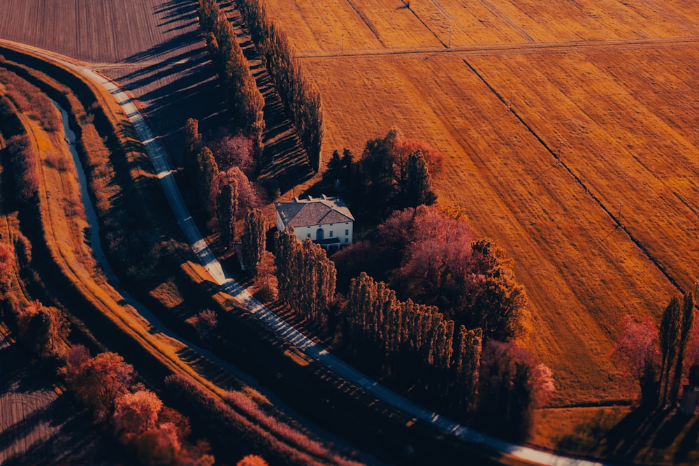an aerial view of a farm and a train track