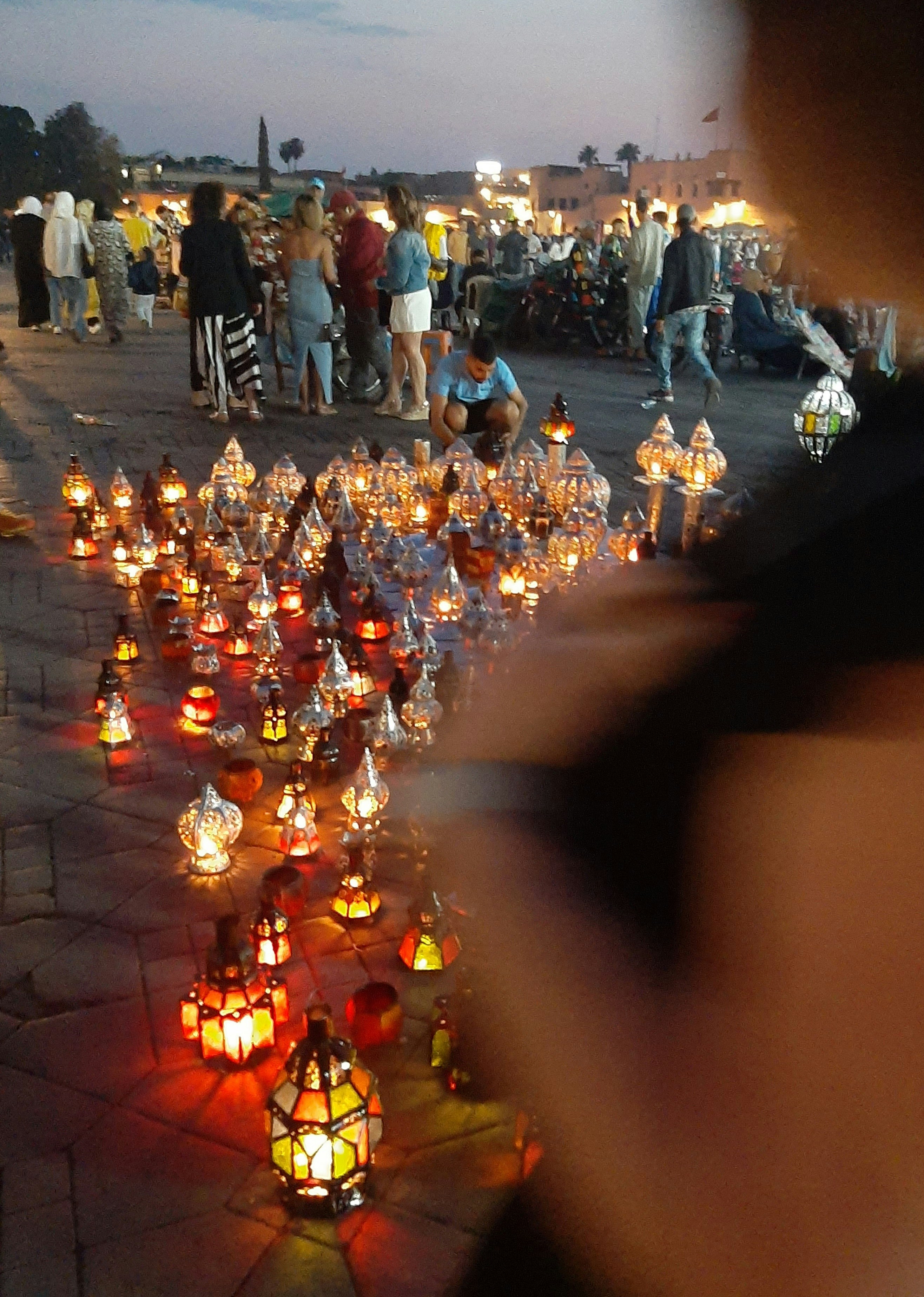 a group of people standing around a lot of lit candles