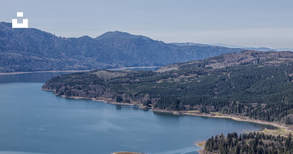 A large body of water surrounded by mountains photo – Free Riffe lake ...