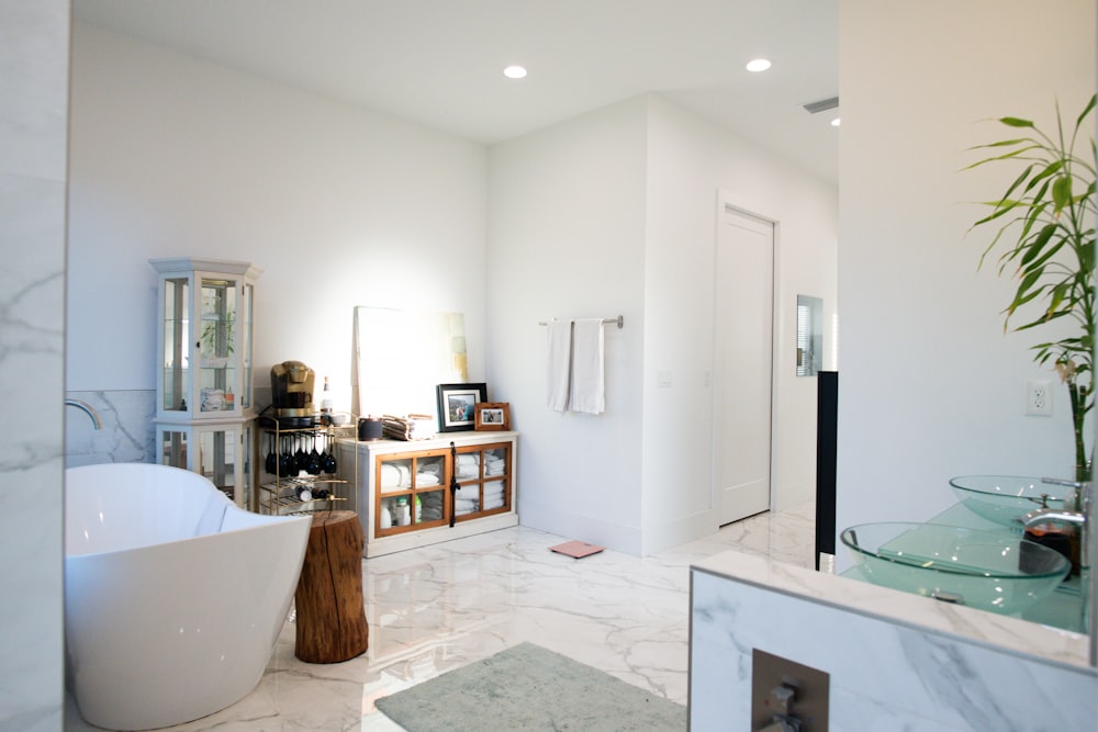 a bathroom with a tub, sink, and a mirror