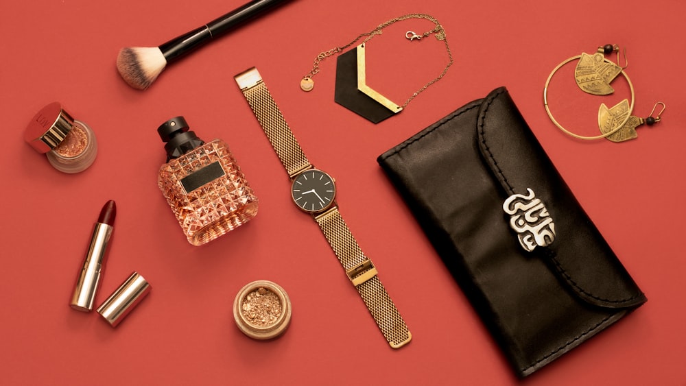 an assortment of women's accessories on a red surface