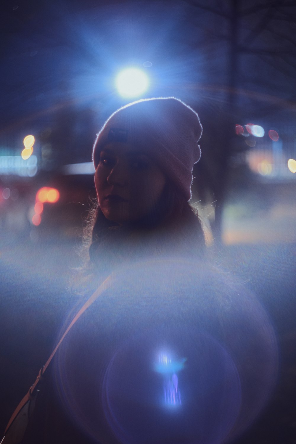 a woman standing in the street at night