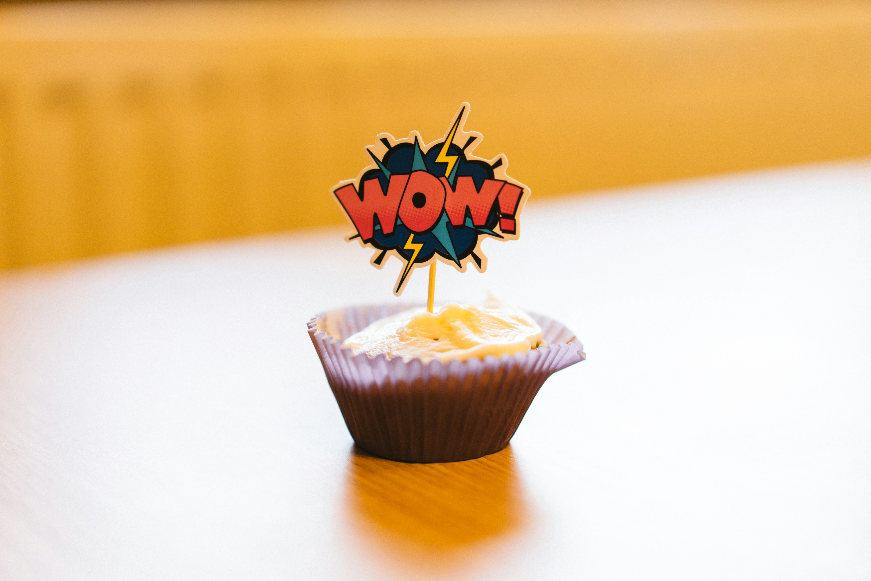 a cupcake with the word wow on top of it