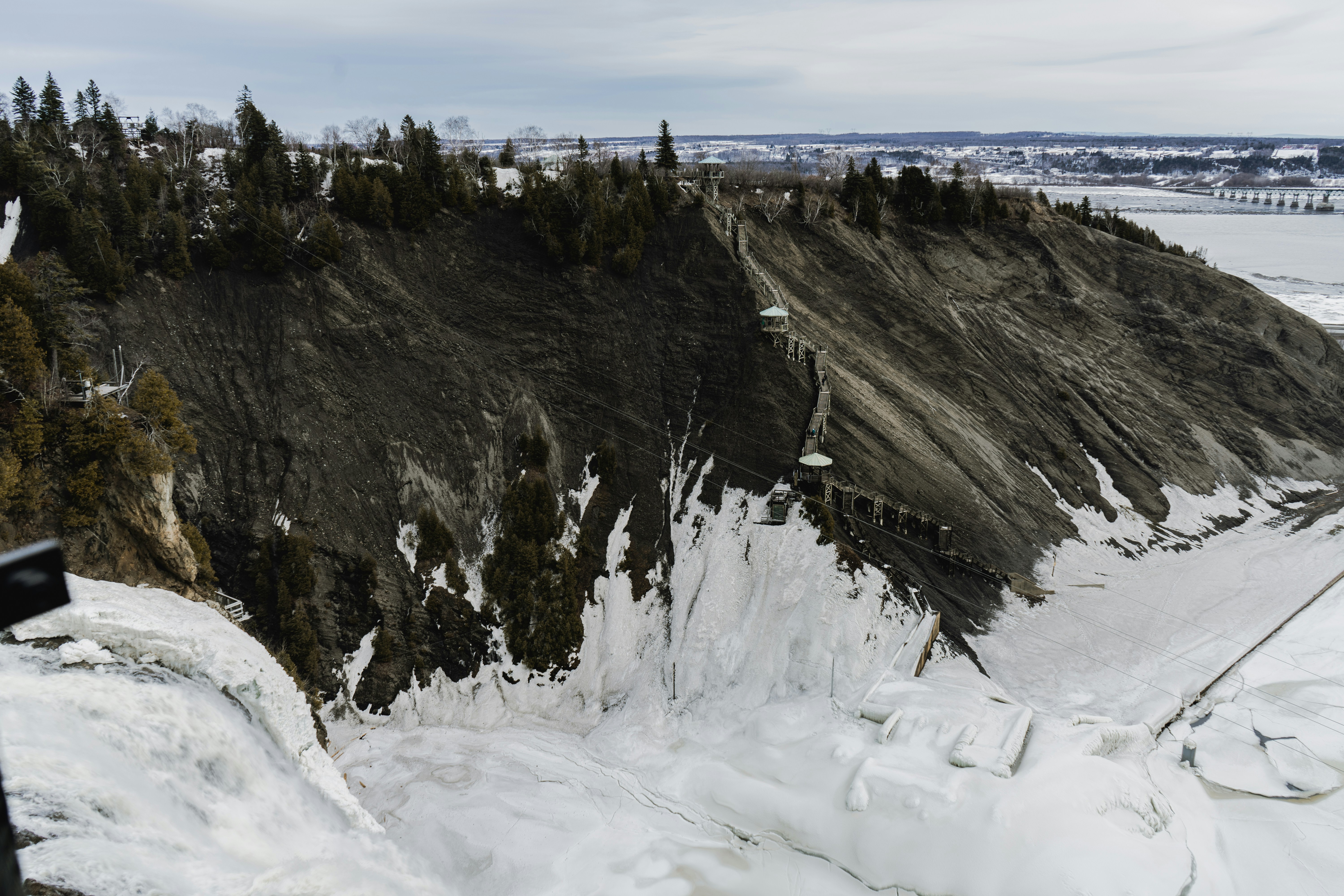 a man standing on top of a snow covered slope