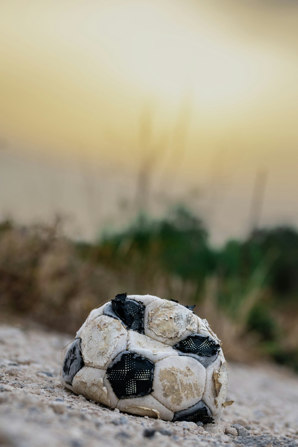 a dirty soccer ball laying on the ground