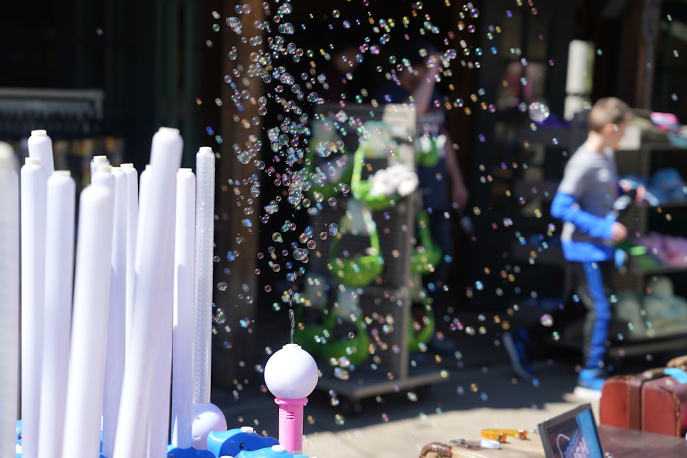 a person is blowing bubbles in front of a store