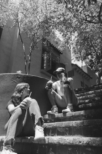 a couple of people sitting on some steps