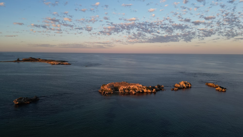 a body of water with rocks in the middle of it