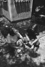 a couple of people that are sitting on the ground