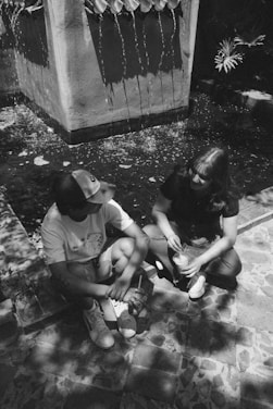 a couple of people that are sitting on the ground