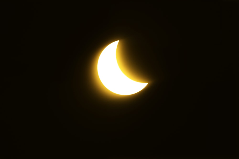 a partial solar eclipse seen through a dark sky