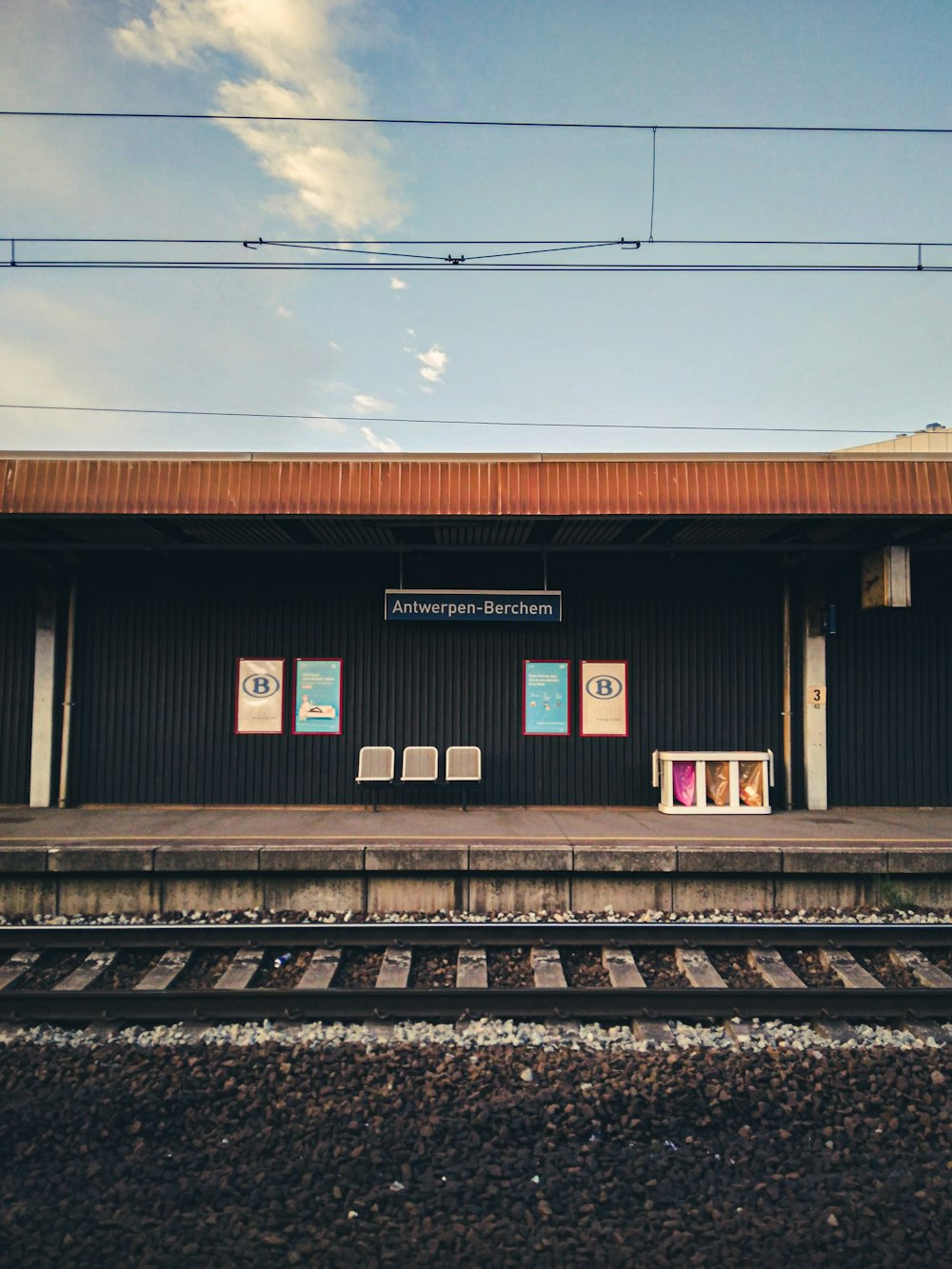 a train station with a train on the tracks