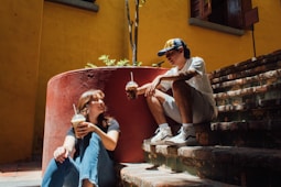 a man and a woman sitting on the steps of a building