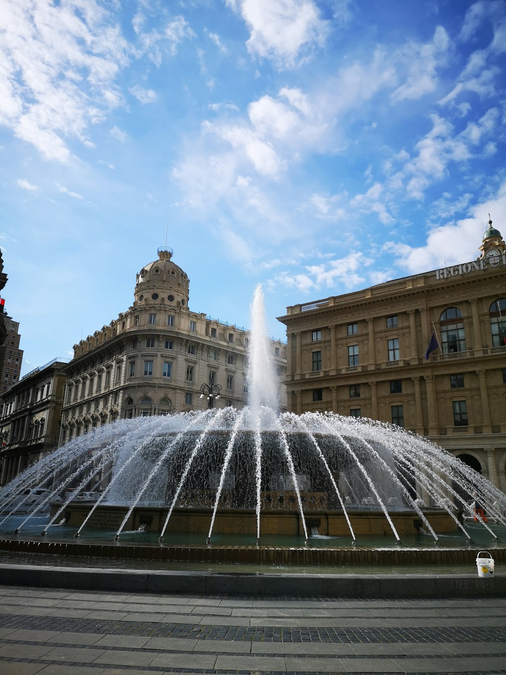 a large water fountain in front of a building