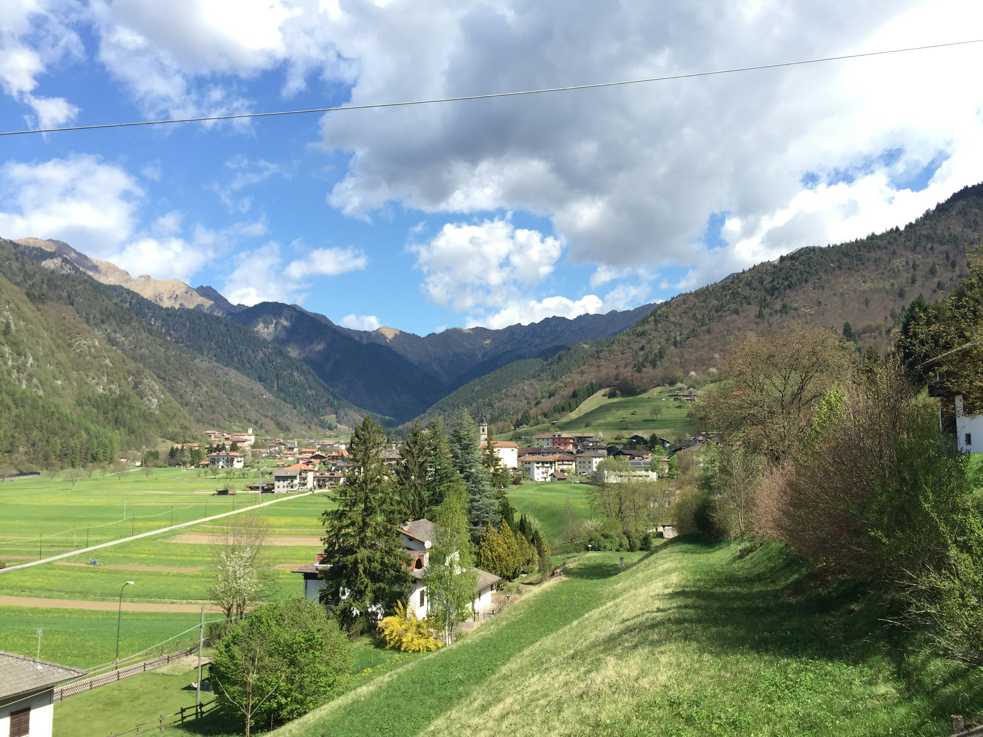 a scenic view of a valley with a mountain in the background