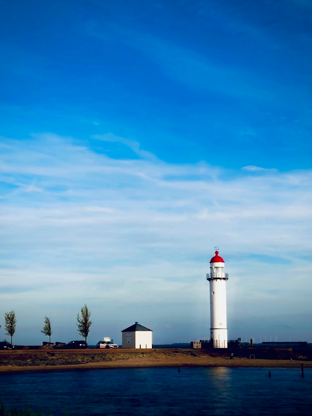 a light house sitting next to a body of water