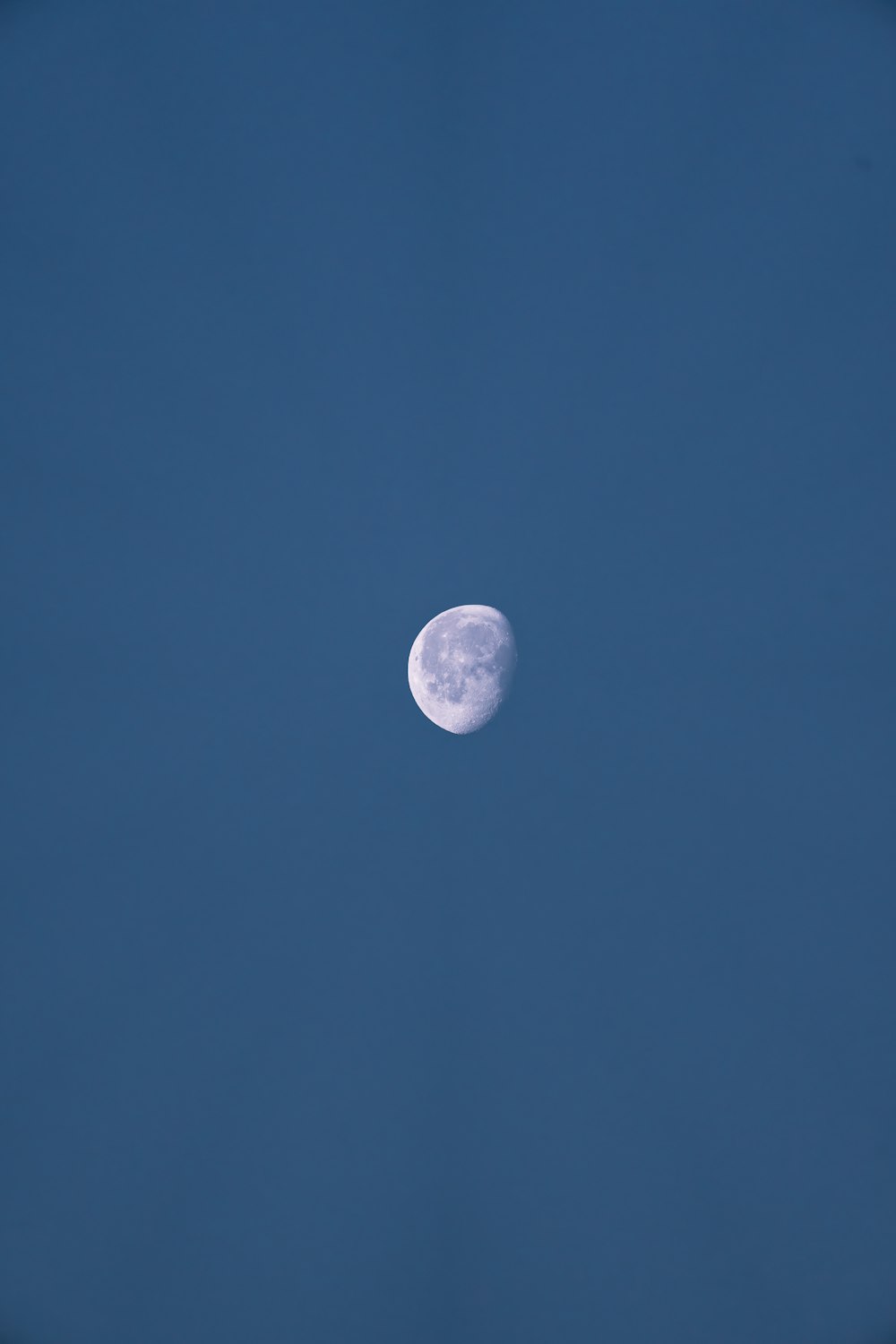 a full moon in a clear blue sky