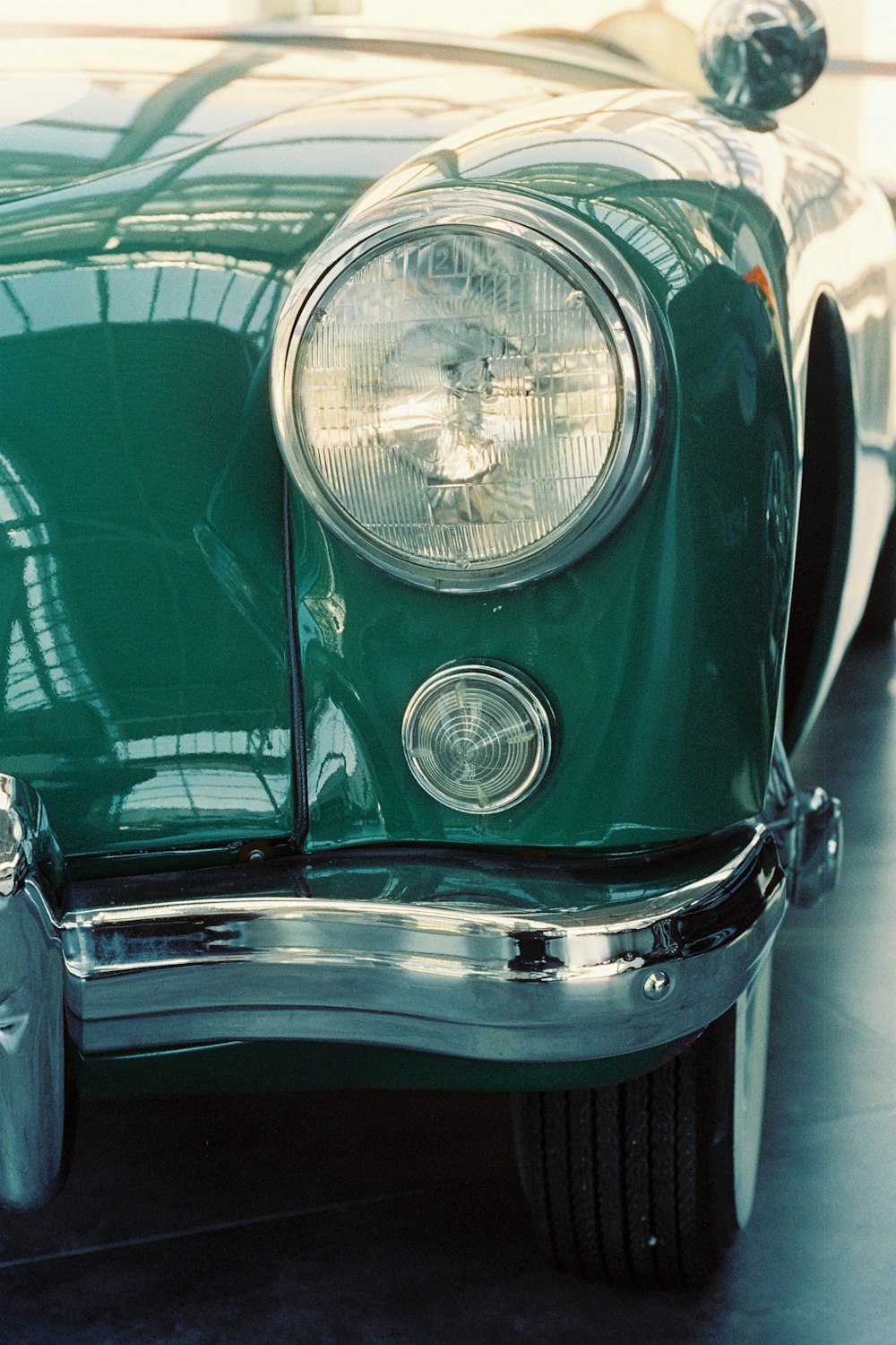 a close up of the front of a green car