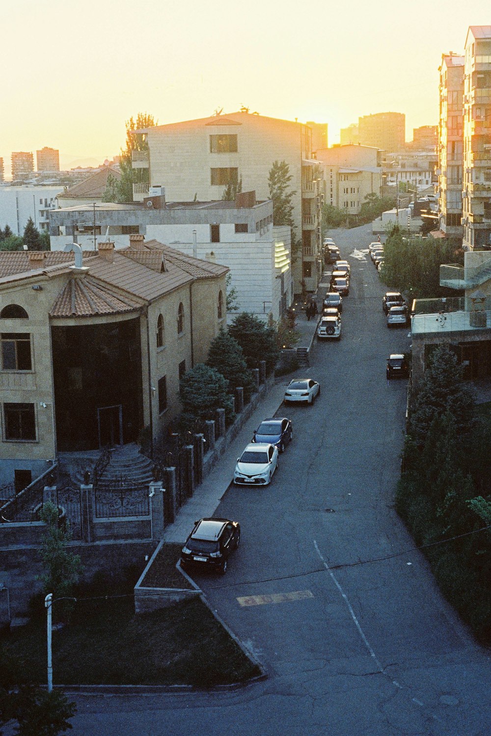 a city street with cars parked on both sides of it