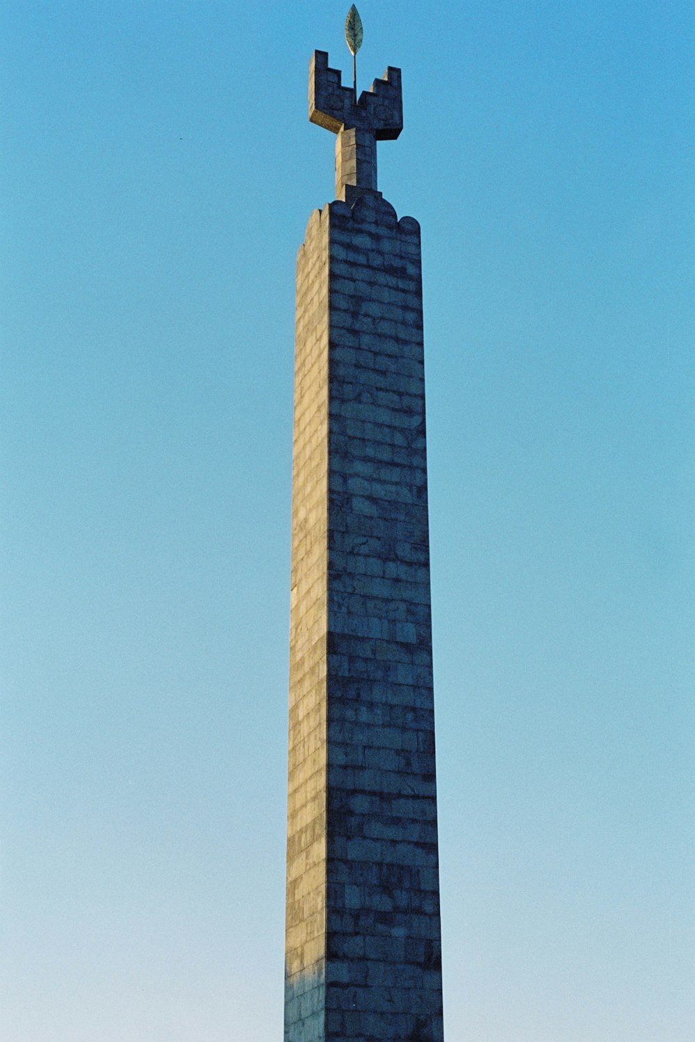 a tall monument with a cross on top of it