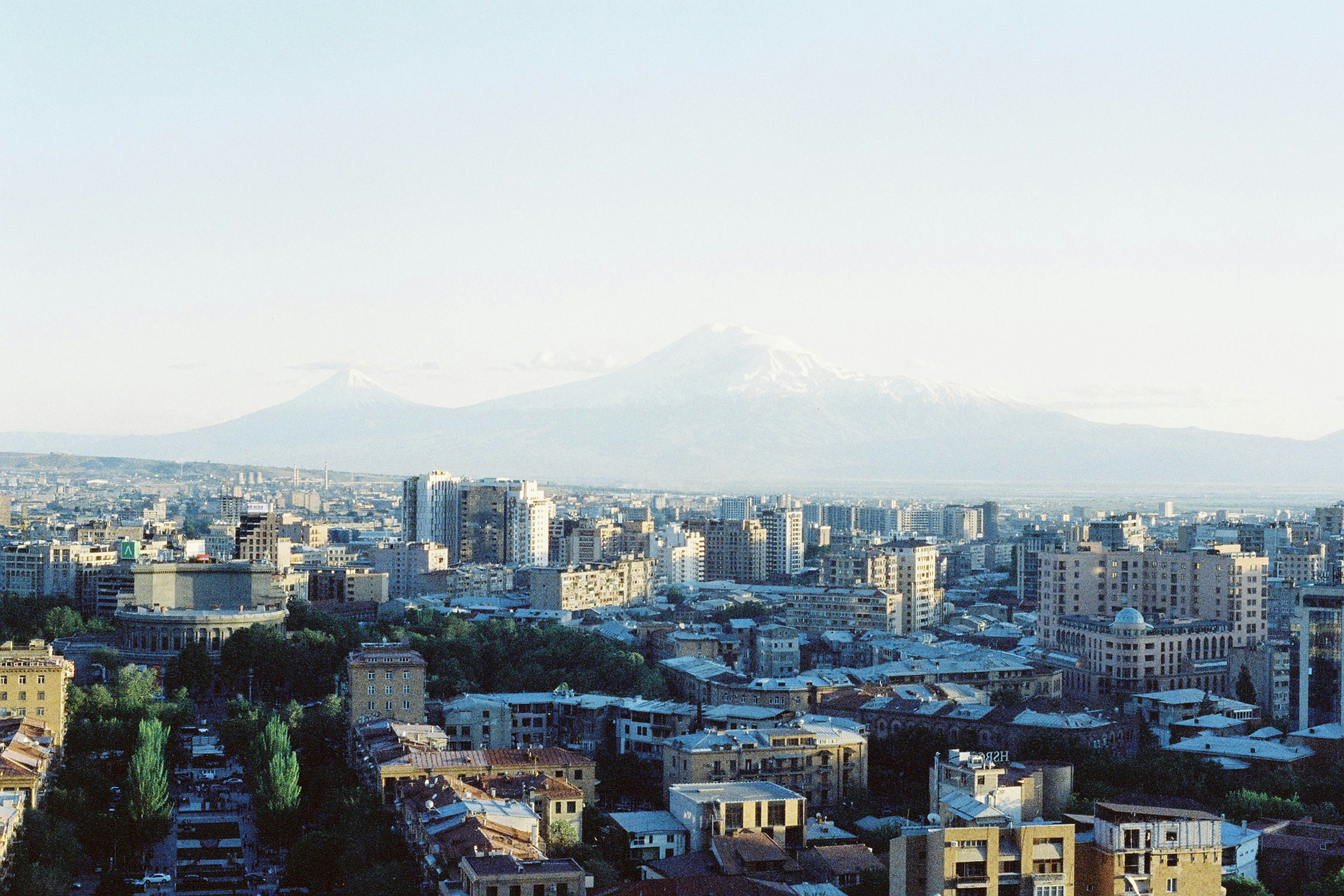 a view of a city with mountains in the background