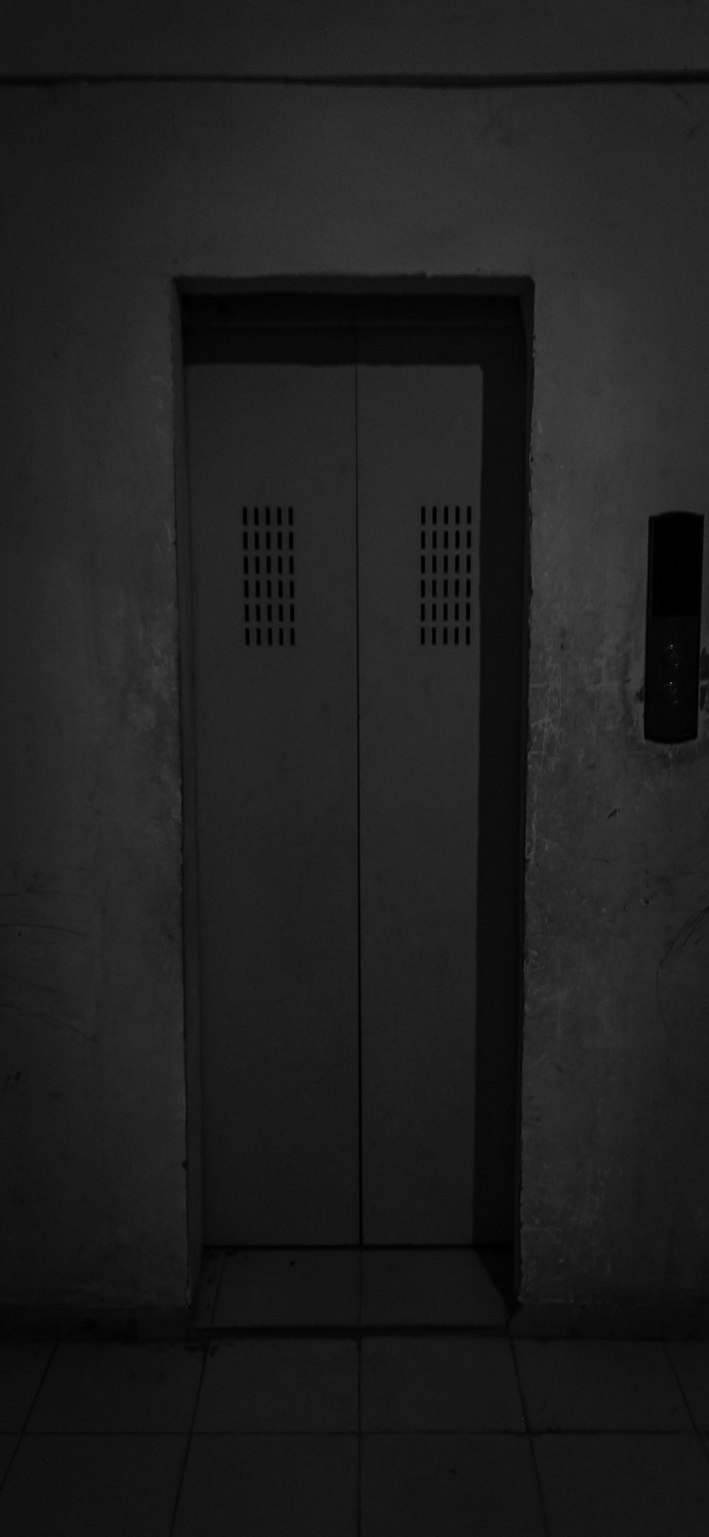 a black and white photo of two doors