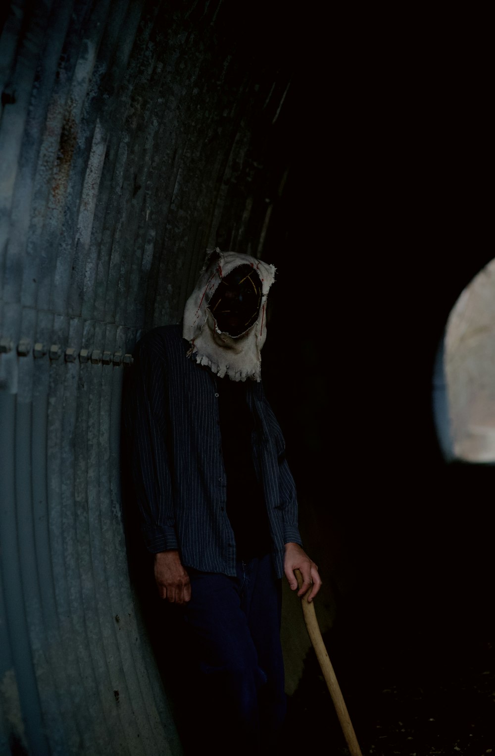 a man wearing a mask and holding a stick