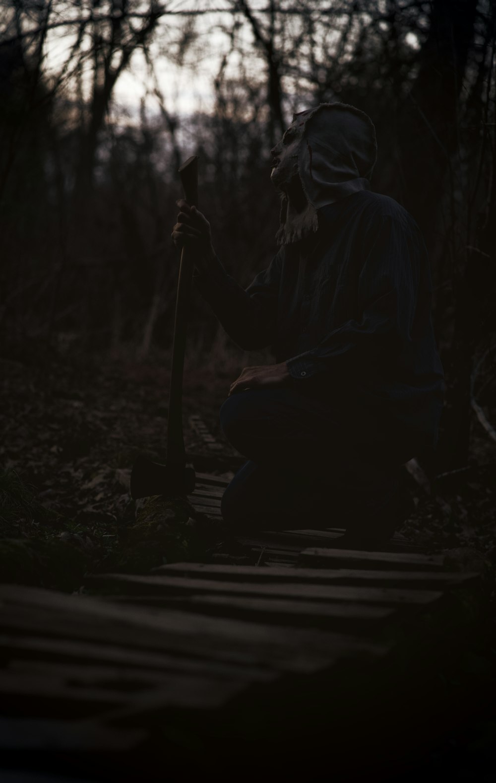 a person sitting on a step in the woods