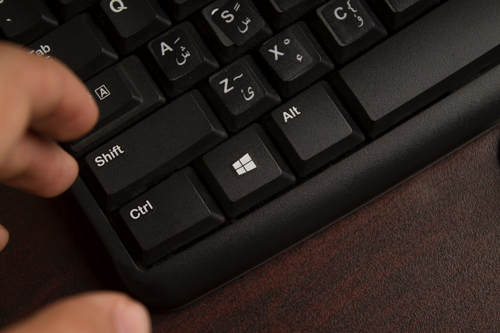 a close up of a person typing on a keyboard