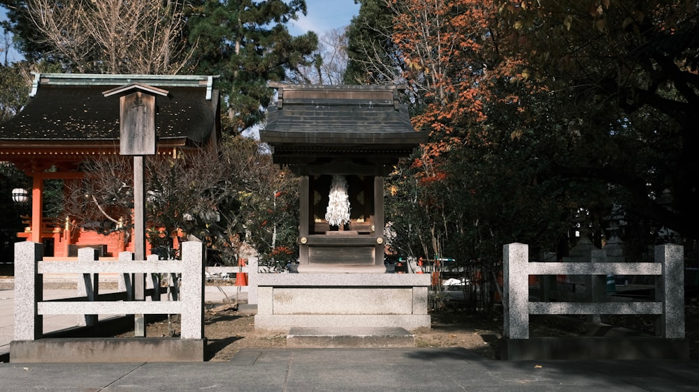 a white gate with a statue in the middle of it