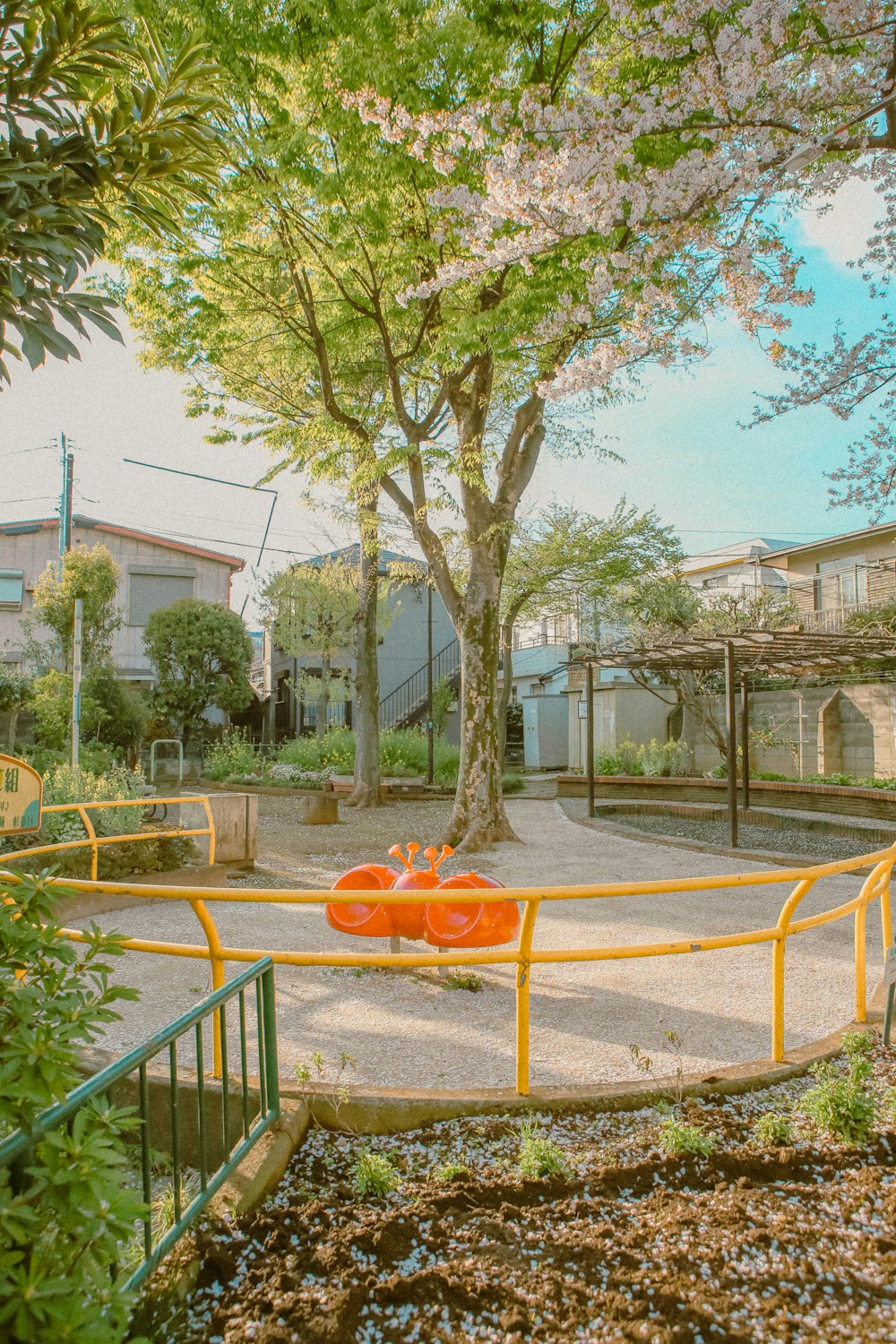 a couple of orange chairs sitting on top of a cement ground