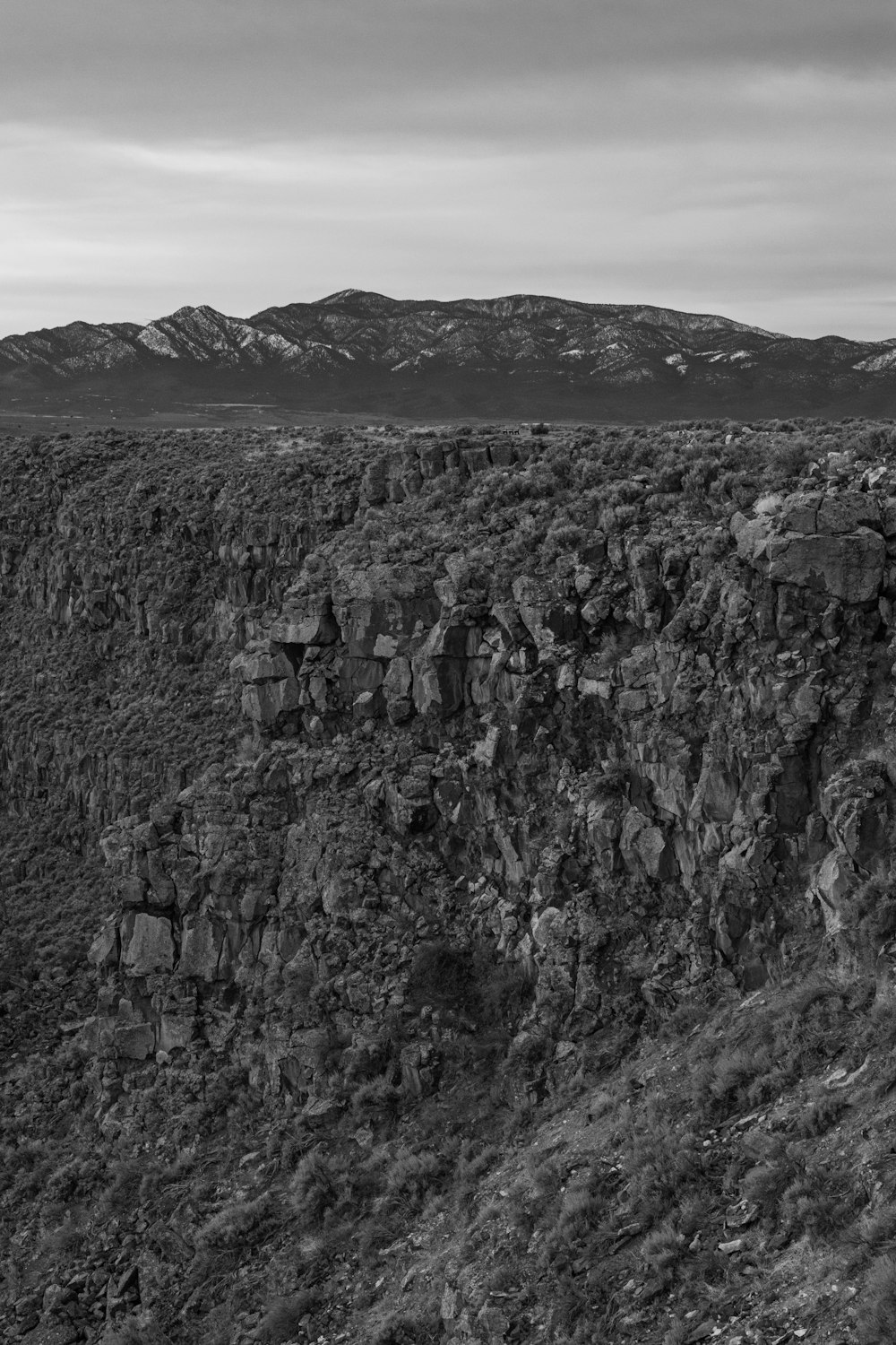 a black and white photo of a rocky mountain