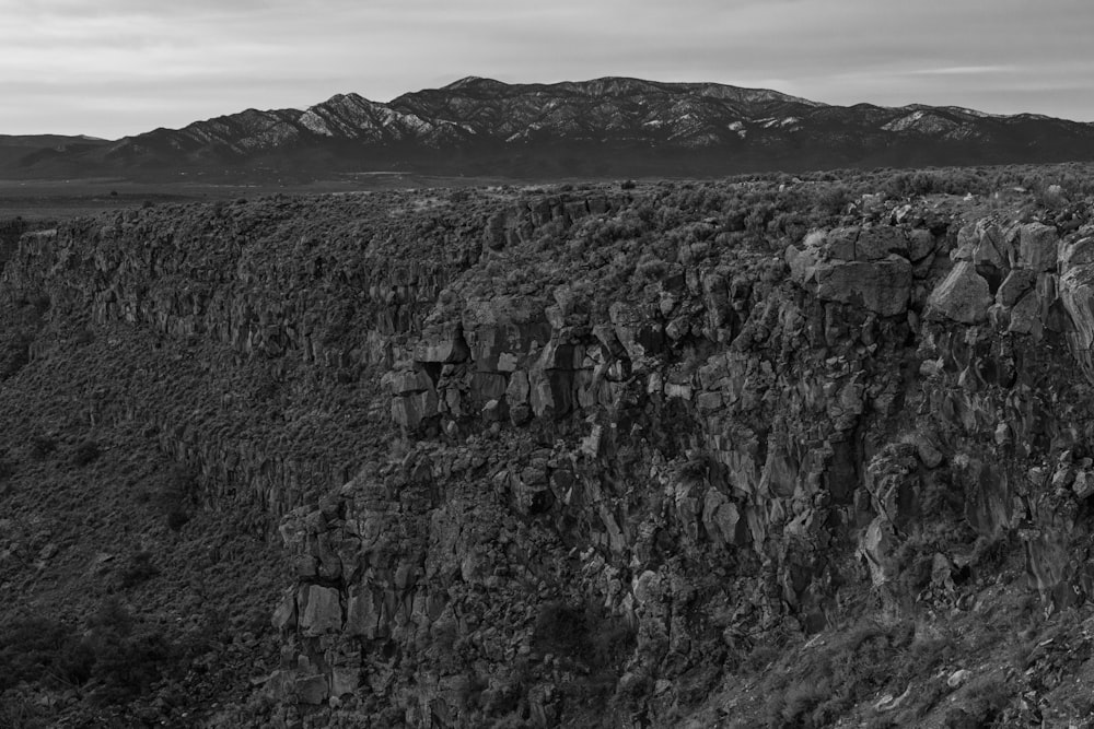 a black and white photo of a rocky cliff