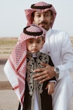 a man and a little boy dressed in traditional clothing