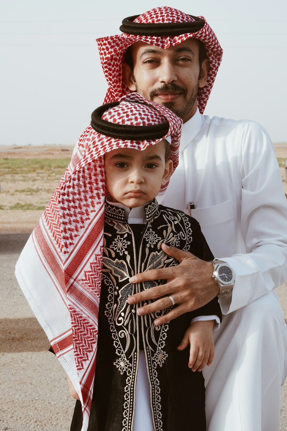 a man and a little boy dressed in traditional clothing