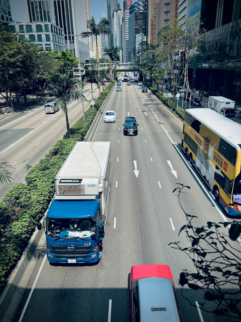 a city street filled with traffic next to tall buildings