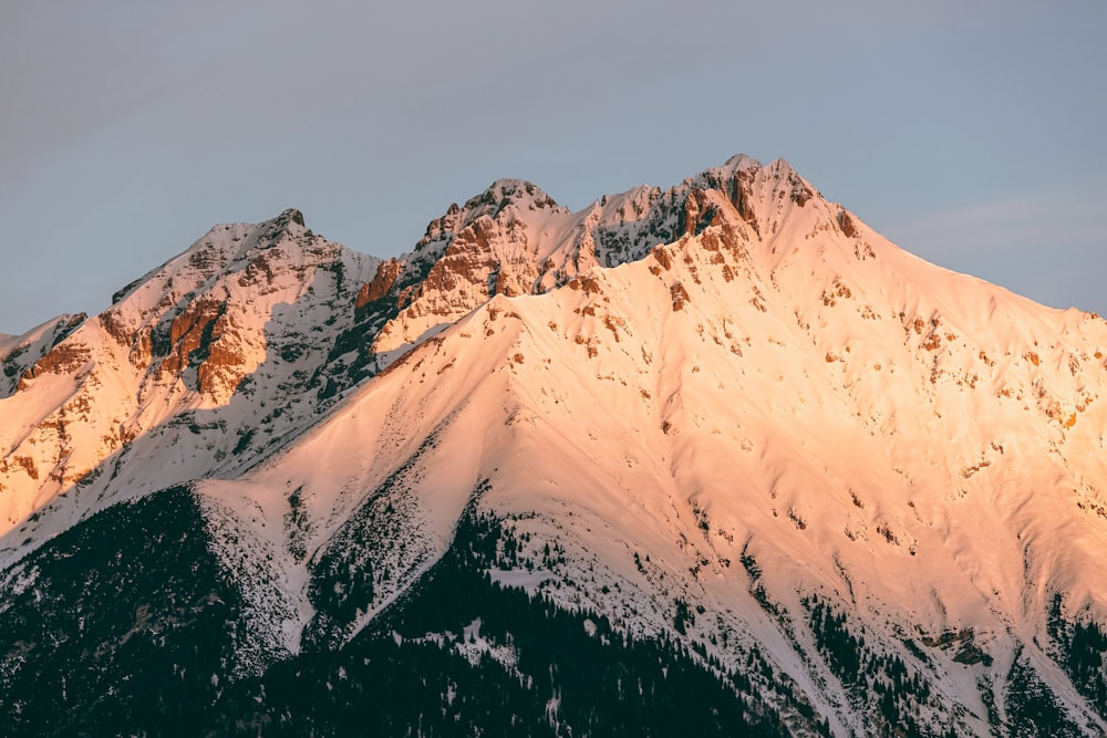 a mountain covered in snow under a blue sky