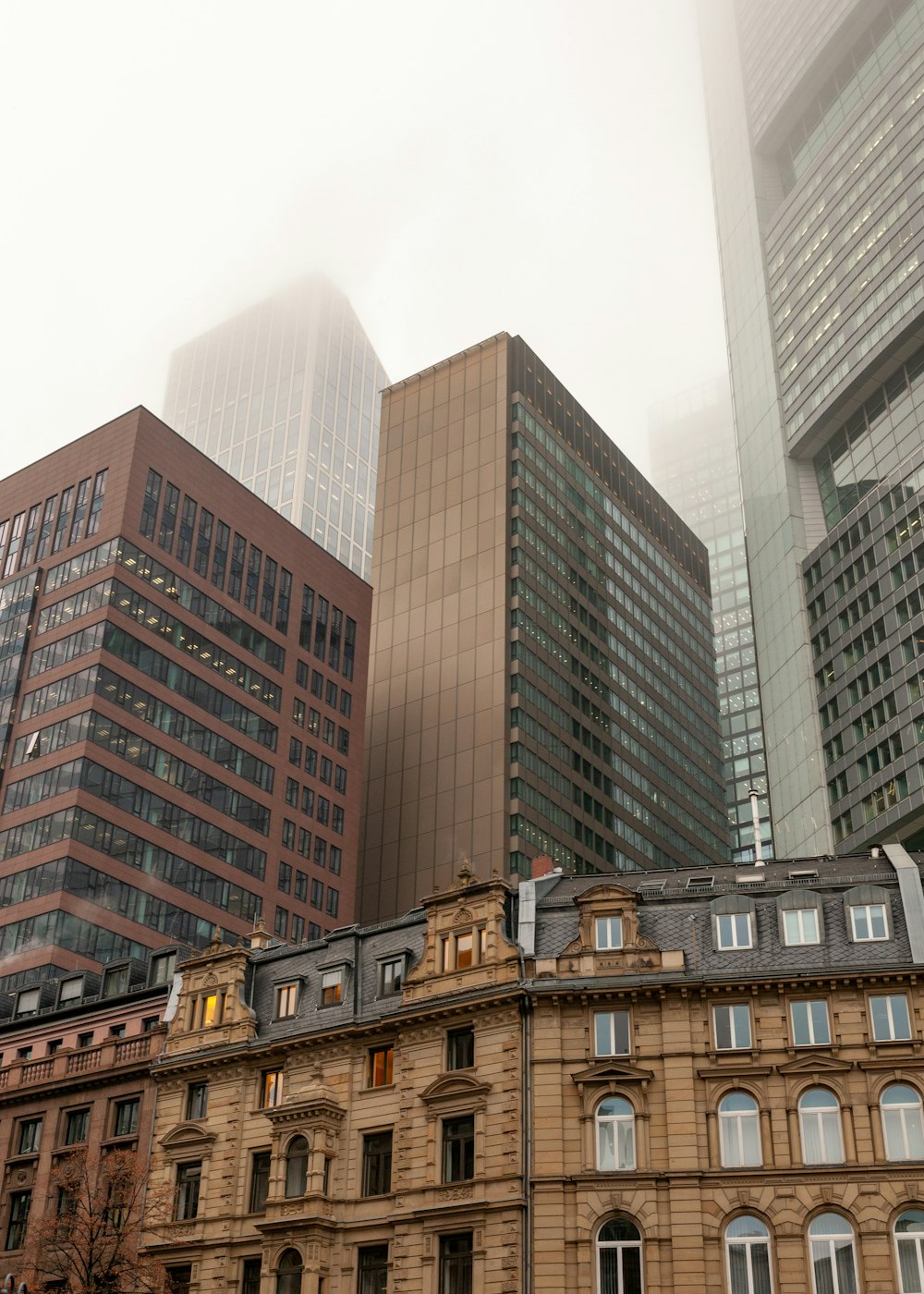 a group of buildings in a city on a foggy day