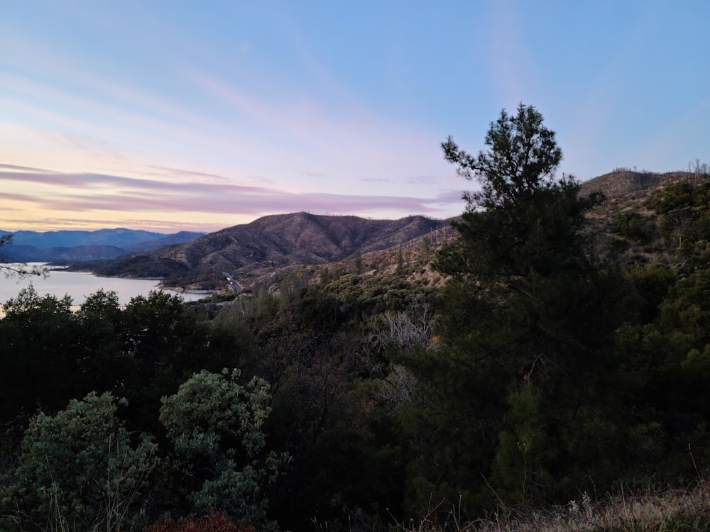 a view of a lake and mountains at sunset