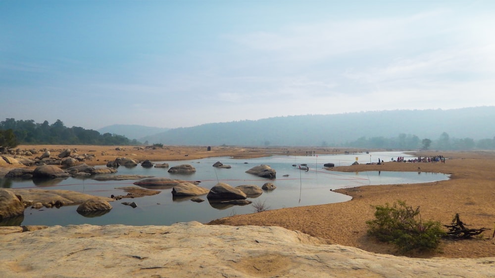 a body of water surrounded by large rocks