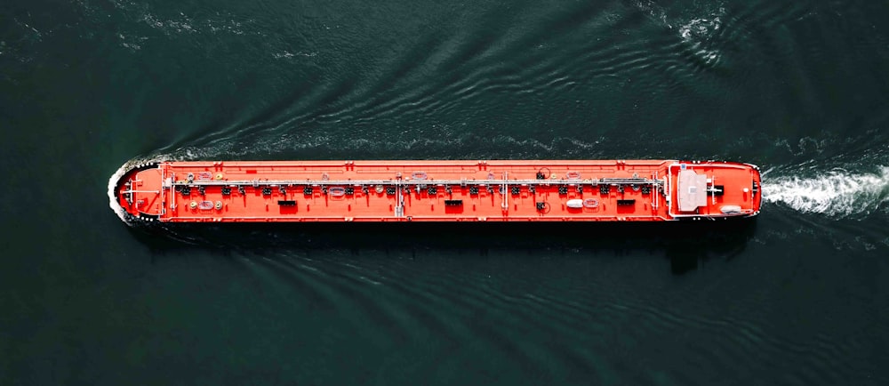 un grand bateau rouge dans un plan d’eau